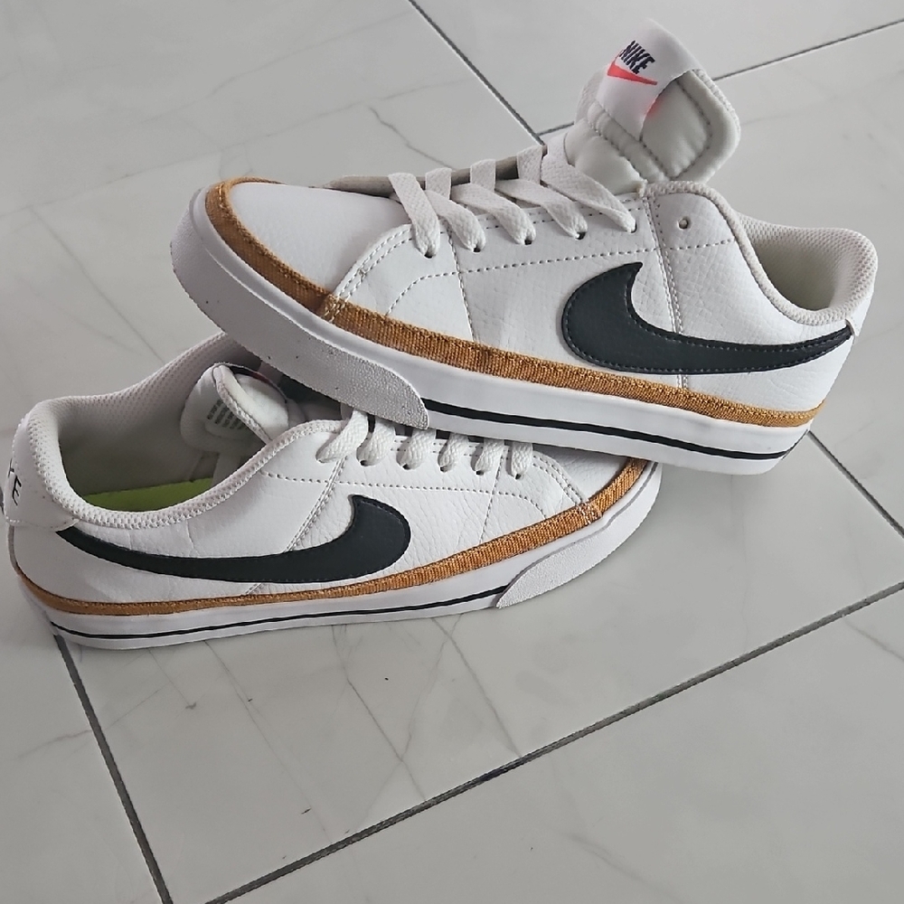Nike Woman's White and Black Sneakers with Gold Accents